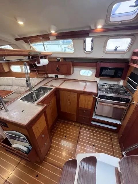 Slide: The Image of Spacious 2001 Hunter 401 yacht kitchen with wood cabinetry and modern appliances. - 22