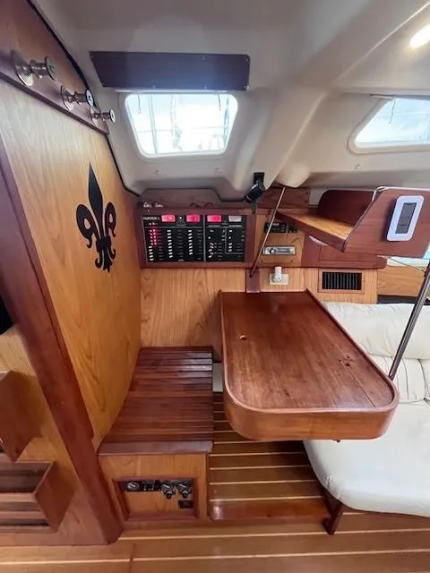 Slide: The Image of Interior of 2001 Hunter 401 sailboat with wooden table and seating area. - 26