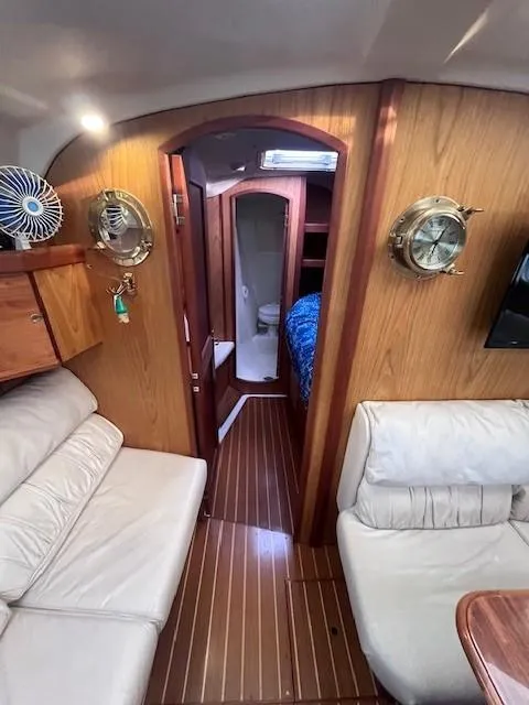 Slide: The Image of Interior of 2001 Hunter 401 yacht with cozy seating and wooden finishes. - 27
