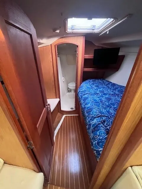 Slide: The Image of Cozy cabin interior of 2001 Hunter 401 yacht with bed, TV, and bathroom. - 28