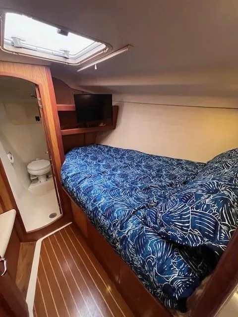 Slide: The Image of Cozy cabin interior of 2001 Hunter 401 sailboat with bed and bathroom. - 29