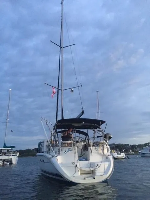 Slide: The Image of Sailboat Hunter 401, 2001 model, anchored on a calm sea under a cloudy sky. - 3