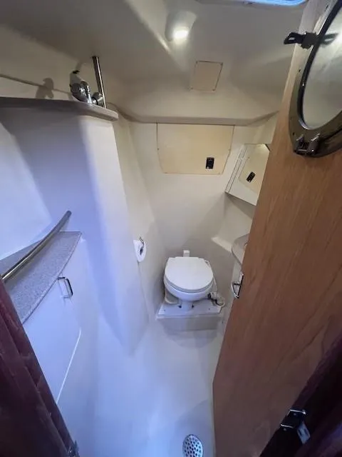 Slide: The Image of Compact bathroom in 2001 Hunter 401 boat with toilet and porthole. - 30