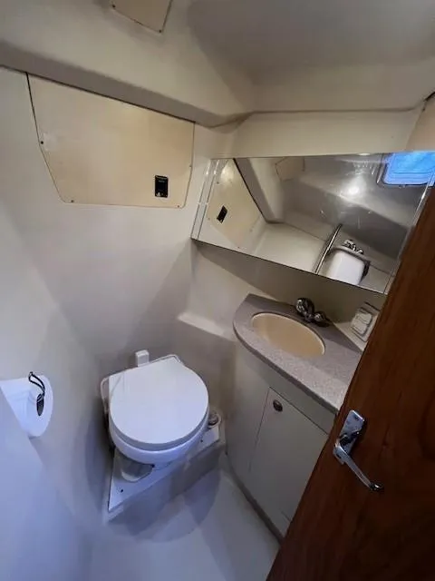 Slide: The Image of 2001 Hunter 401 yacht bathroom with toilet, sink, and mirror. - 31