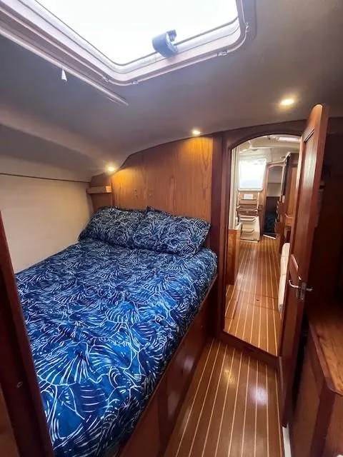 Slide: The Image of Cozy cabin interior of 2001 Hunter 401 sailboat with blue bedding. - 32