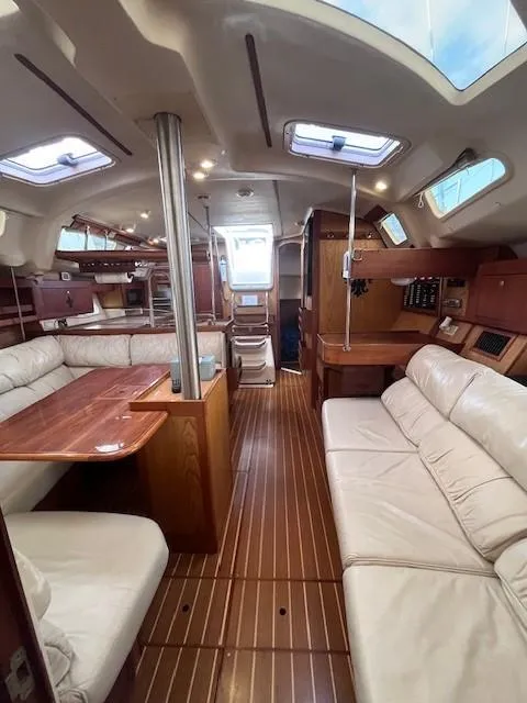 Slide: The Image of Spacious 2001 Hunter 401 yacht interior with wood flooring and comfortable seating. - 33
