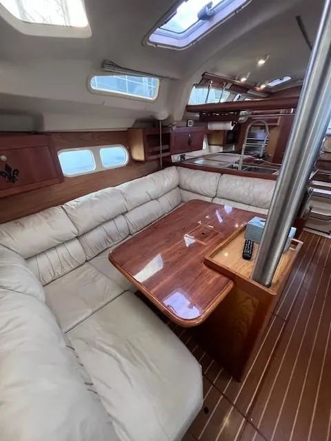 Slide: The Image of Interior of 2001 Hunter 401 sailboat with plush seating and wooden table. - 34