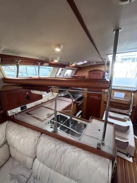 Slide: The Image of Interior of 2001 Hunter 401 sailboat with modern kitchen and seating area. - 35