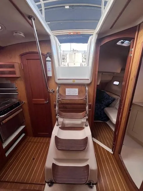 Slide: The Image of Interior of 2001 Hunter 401 sailboat with wooden flooring and cozy cabin layout. - 36