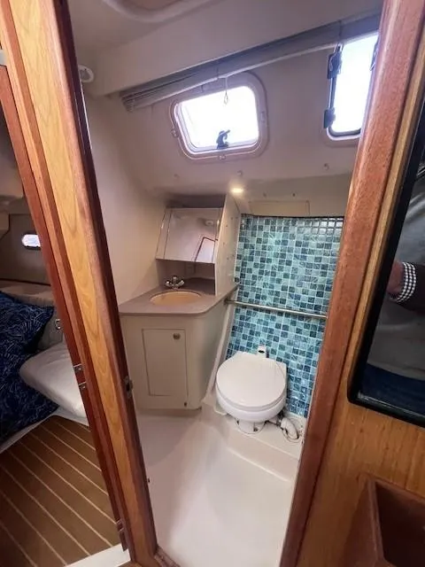 Slide: The Image of 2001 Hunter 401 yacht bathroom with mosaic tiles and compact design. - 37