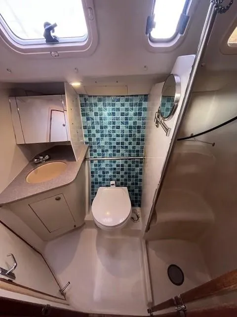 Slide: The Image of Compact bathroom in 2001 Hunter 401 yacht with blue tile accents. - 38