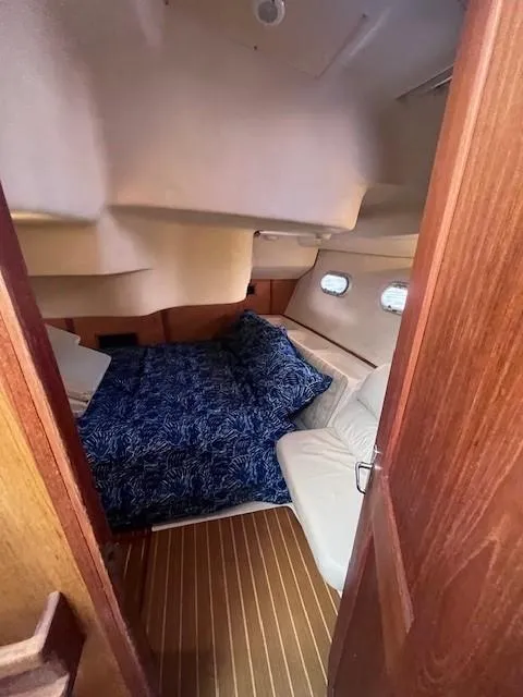 Slide: The Image of Cozy cabin interior of 2001 Hunter 401 sailboat with blue bedding and wooden accents. - 39