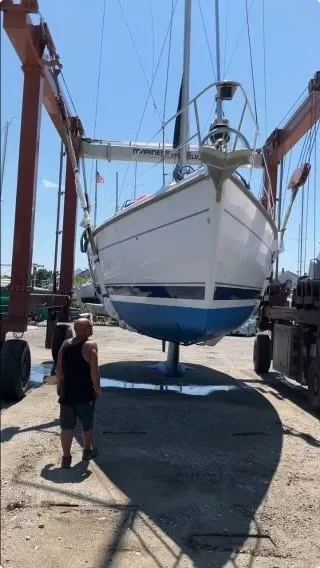 Slide: The Image of Hunter 401 sailboat from 2001 being lifted in a boatyard. - 4