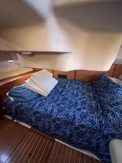 Slide: The Image of Cozy cabin interior of 2001 Hunter 401 yacht with blue patterned bedding. - 40