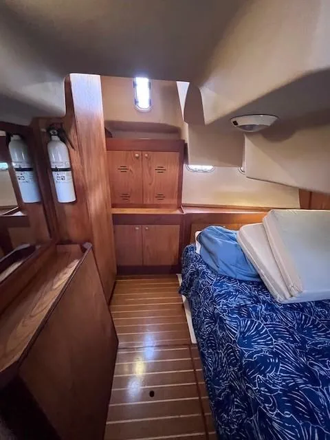 Slide: The Image of Cozy cabin interior of 2001 Hunter 401 sailboat with wooden furnishings and bedding. - 41