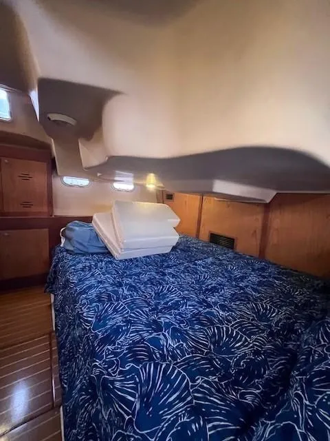 Slide: The Image of Cozy cabin interior of 2001 Hunter 401 sailboat with blue bedding. - 42