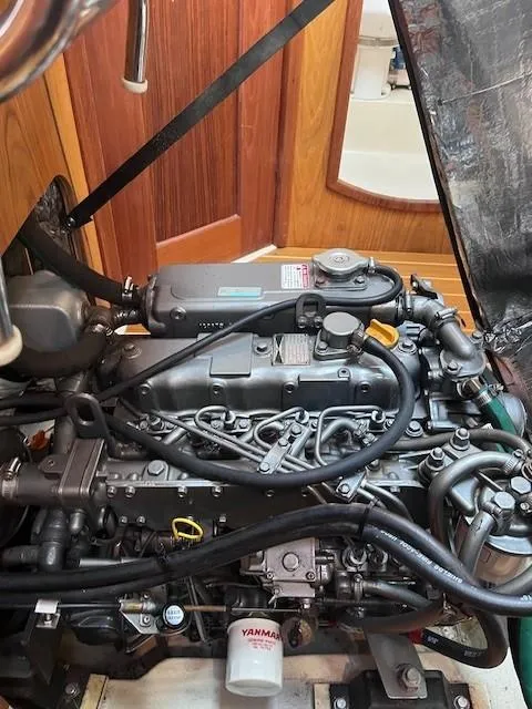 Slide: The Image of 2001 Hunter 401 engine compartment with Yanmar components and detailed wiring. - 47