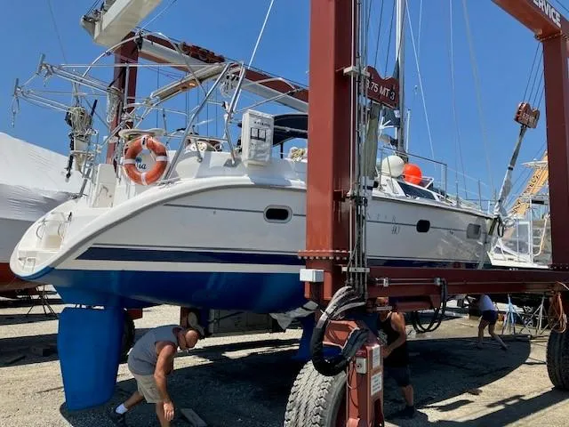 Slide: The Image of Hunter 401 sailboat from 2001 being lifted for maintenance at a marina. - 6