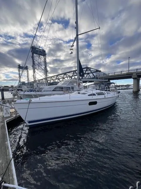Slide: The Image of Sailboat docked near bridge under cloudy sky, Hunter 401, 2001 model. - 8