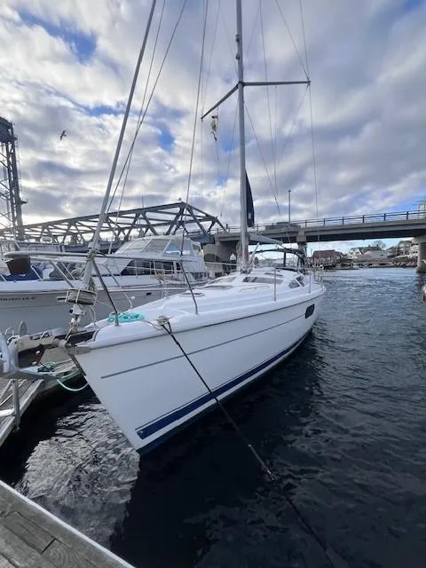 Slide: The Image of White 2001 Hunter 401 sailboat docked at marina under cloudy sky. - 9