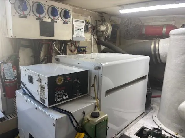 Slide: The Image of Engine room of a 1990 Viking Convertible with generator and control panels. - 41