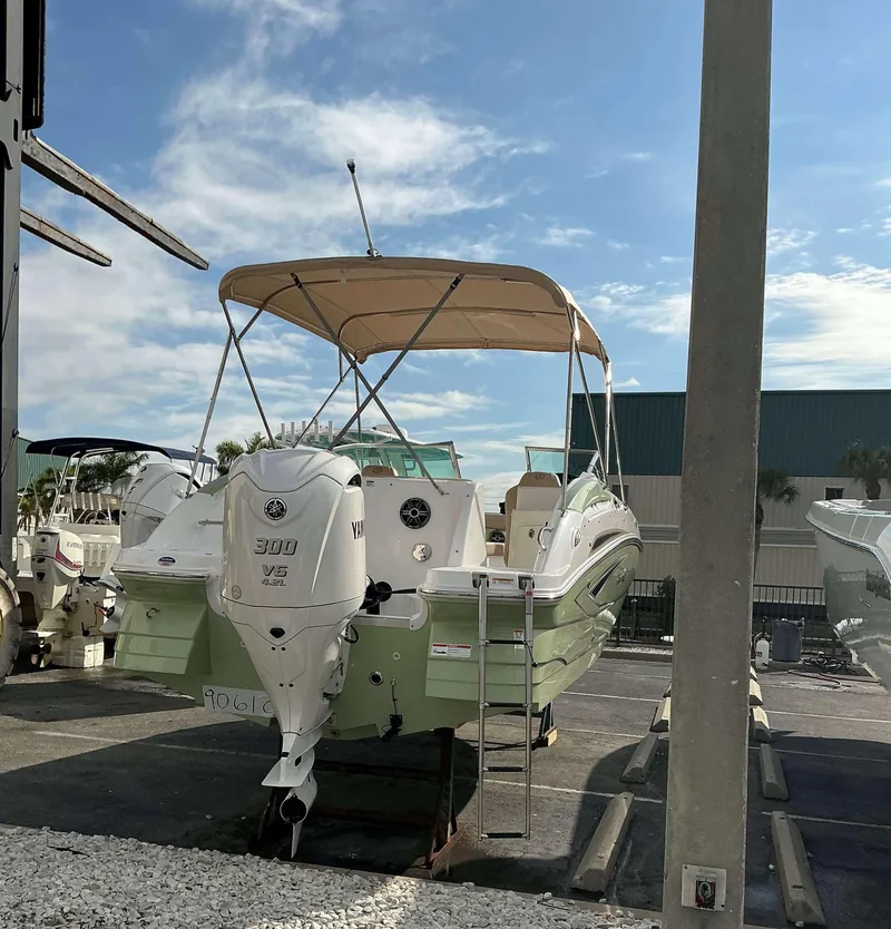 Slide: The Image of 2025 Hurricane 2400 SD boat with Yamaha 300 V6 engine, parked outdoors. - 10