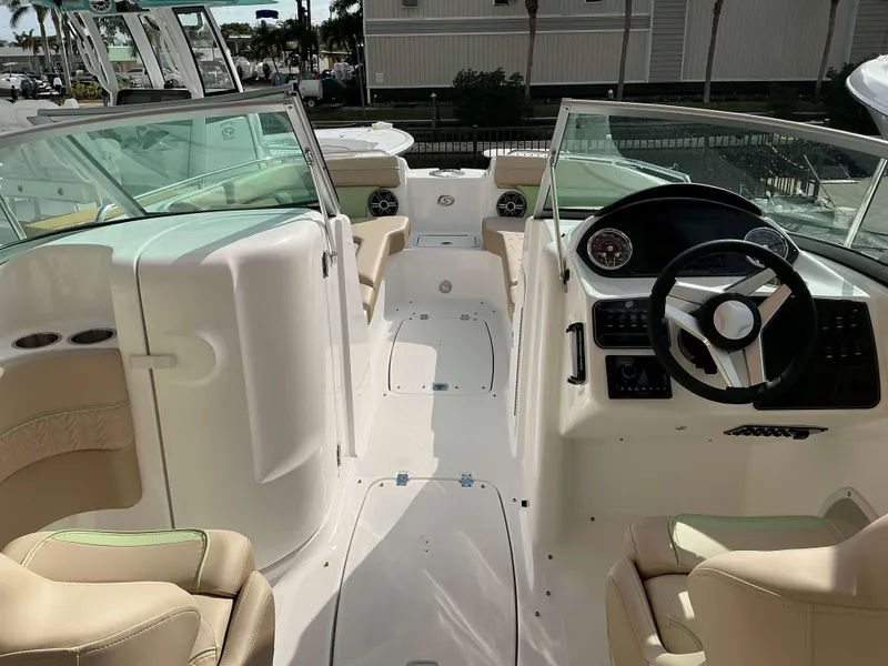 Slide: The Image of 2025 Hurricane 2400 SD boat interior with steering wheel and seating. - 12