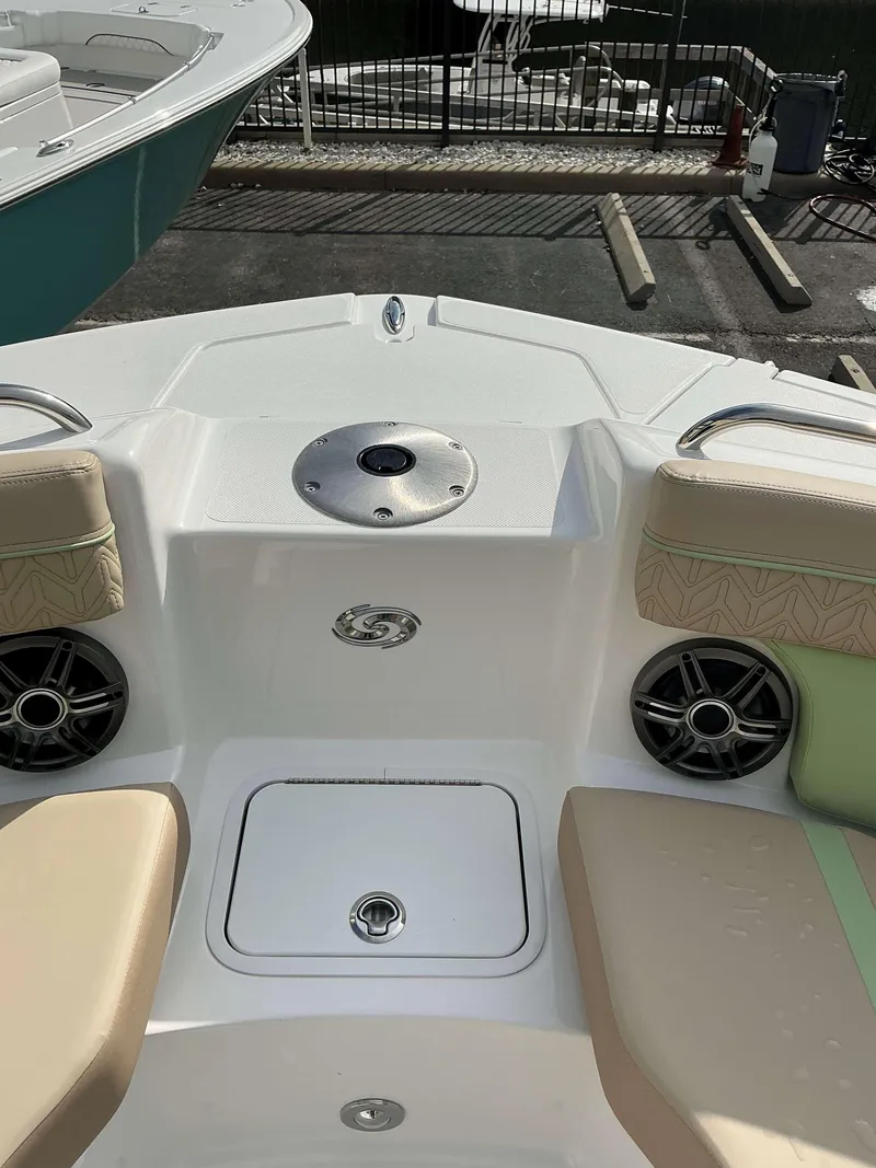 Slide: The Image of 2025 Hurricane 2400 SD boat interior with seating and speakers. - 15