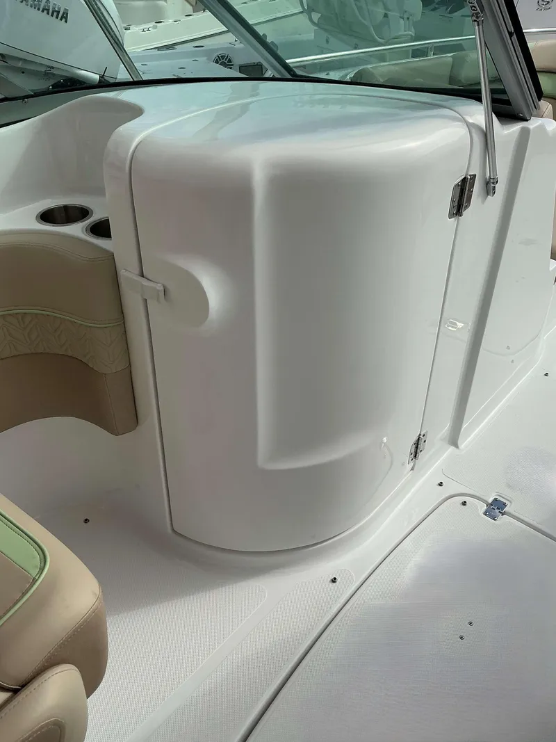 Slide: The Image of 2025 Hurricane 2400 SD boat interior with white console and seating. - 16