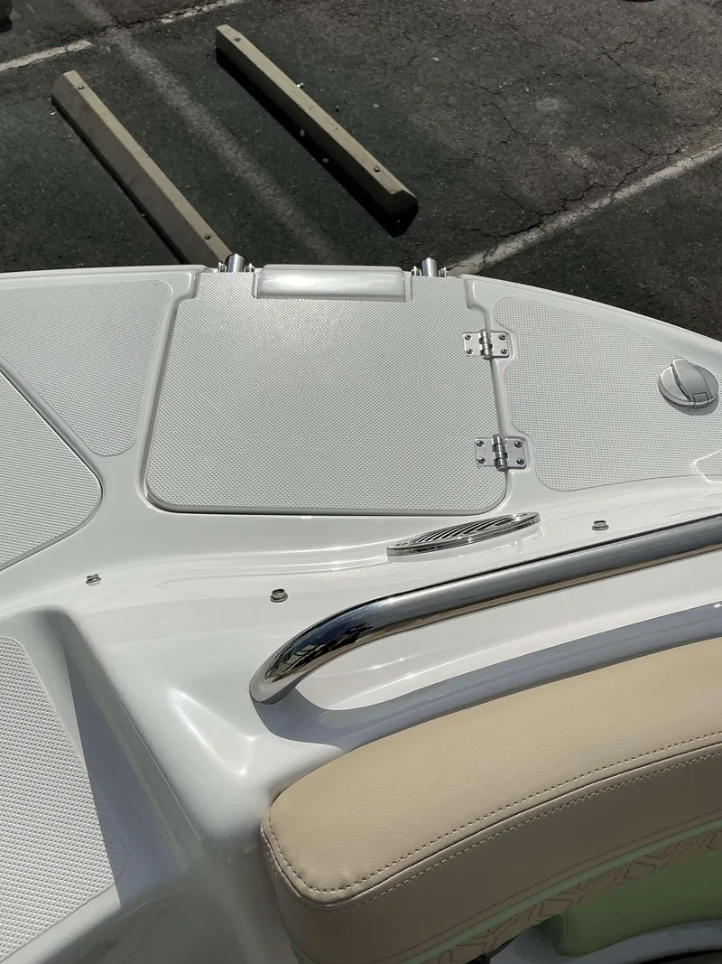 Slide: The Image of 2025 Hurricane 2400 SD boat deck with beige seating and stainless steel railing. - 18