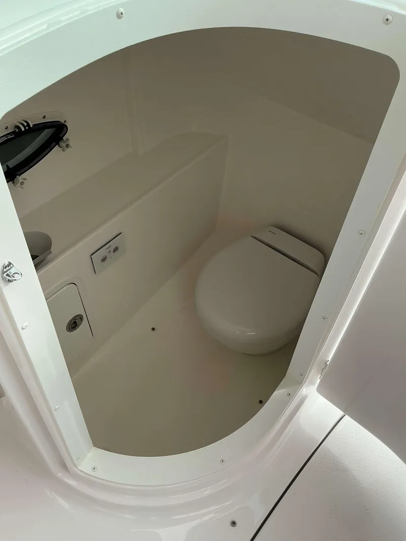 Slide: The Image of 2025 Hurricane 2400 SD boat interior with compact marine toilet. - 19