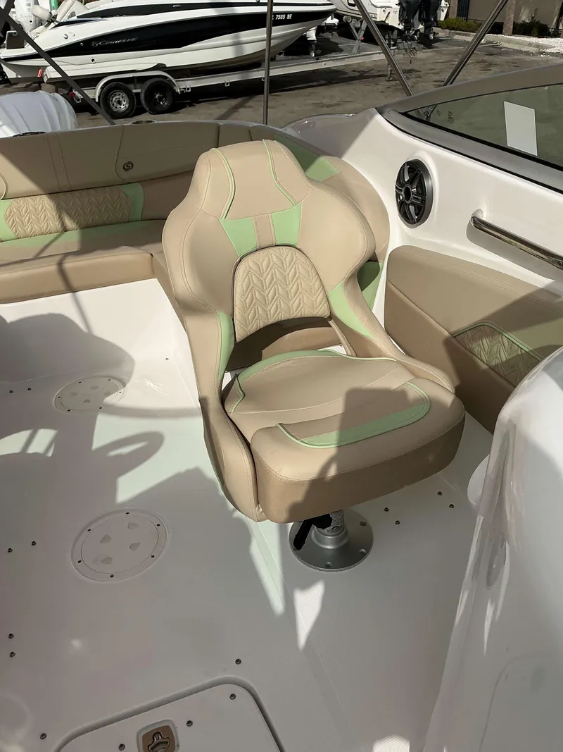 Slide: The Image of 2025 Hurricane 2400 SD boat interior with beige and green seating. - 4