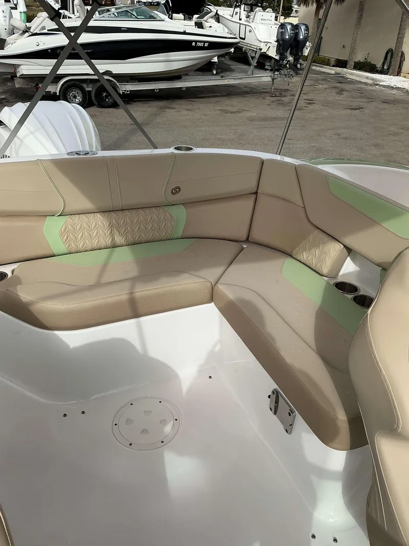 Slide: The Image of 2025 Hurricane 2400 SD boat interior with beige and green seating. - 5