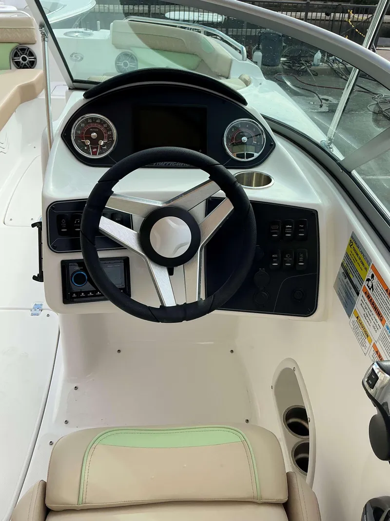 Slide: The Image of 2025 Hurricane 2400 SD boat dashboard with steering wheel and controls. - 8