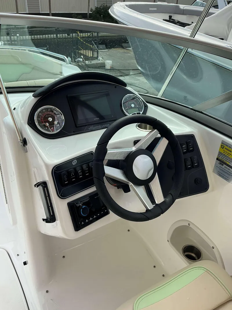 Slide: The Image of 2025 Hurricane 2400 SD boat dashboard with steering wheel and control panel. - 9