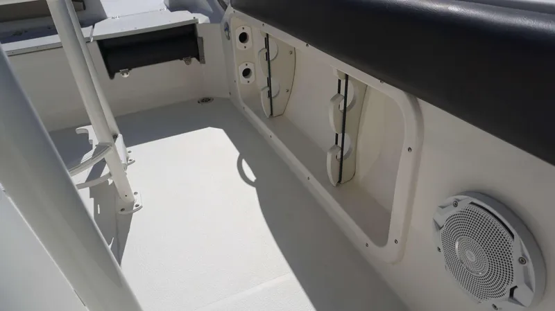 Slide: The Image of 2019 Stingray 216 CC boat interior with storage compartments and speaker. - 10
