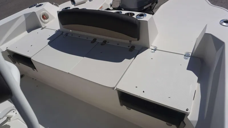 Slide: The Image of 2019 Stingray 216 CC boat interior with seating and storage compartments. - 12