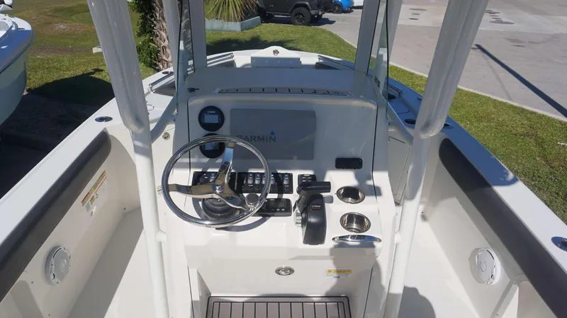 Slide: The Image of 2019 Stingray 216 CC boat console with steering wheel and Garmin navigation system. - 13