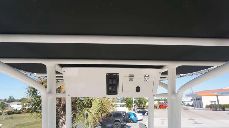 Slide: The Image of 2019 Stingray 216 CC boat console with overhead storage and control panel. - 14