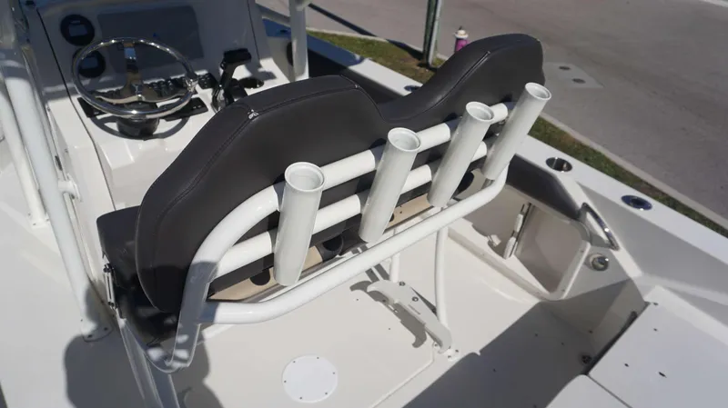 Slide: The Image of 2019 Stingray 216 CC boat interior with rod holders and steering wheel. - 15