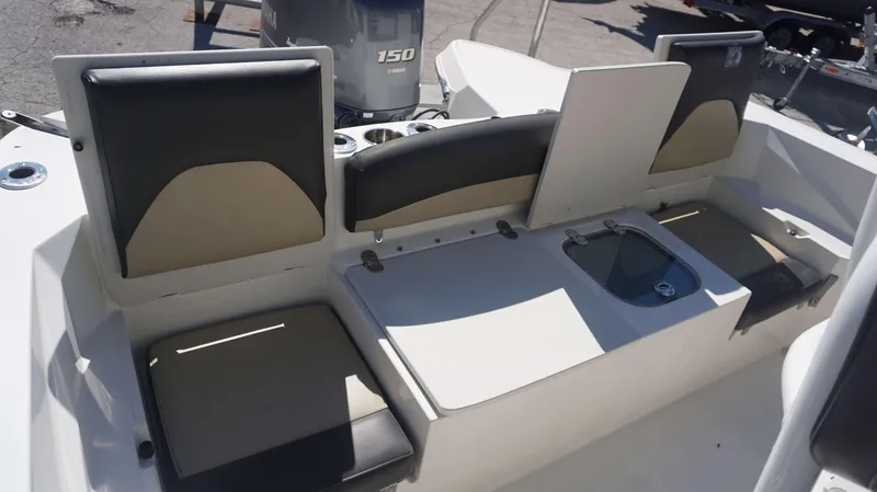 Slide: The Image of 2019 Stingray 216 CC boat seating area with Yamaha 150 engine in background. - 18