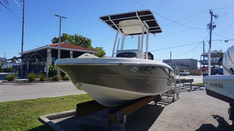 Slide: The Image of 2019 Stingray 216 CC boat on display in a sunny outdoor setting. - 3