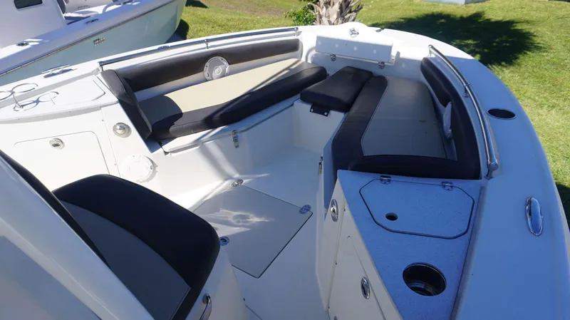 Slide: The Image of 2019 Stingray 216 CC boat interior with cushioned seating and storage compartments. - 6