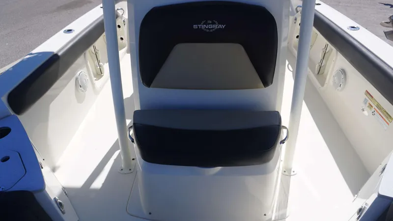 Slide: The Image of 2019 Stingray 216 CC boat interior with seating and console. - 8