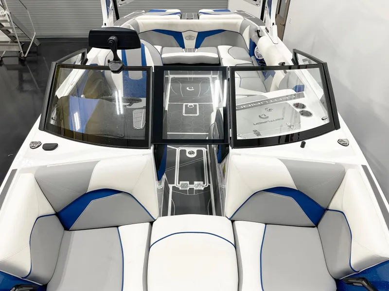 Slide: The Image of 2025 Centurion Fe23 boat interior with white and blue seating, sleek design. - 7