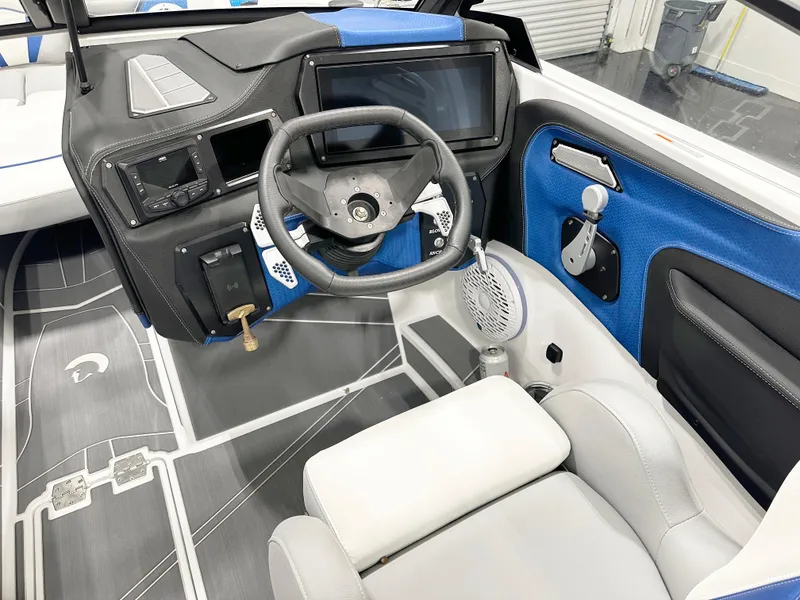 Slide: The Image of 2025 Centurion Fe23 boat interior with modern dashboard and steering wheel. - 8
