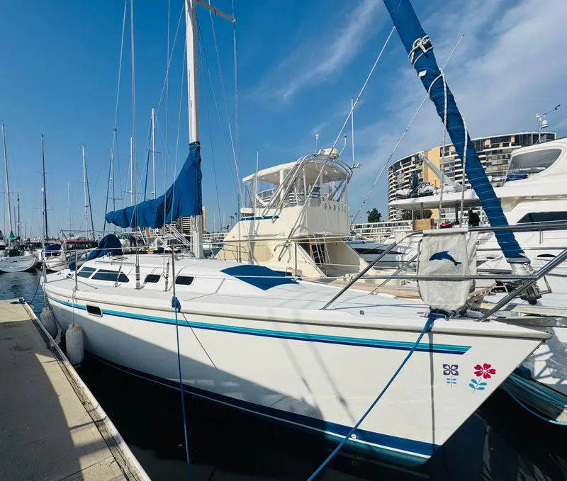 Slide: The Image of 1998 Catalina 320 sailboat docked at marina under clear blue sky. - 0