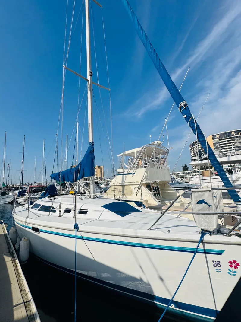 Slide: The Image of 1998 Catalina 320 sailboat docked at marina under clear blue sky. - 1