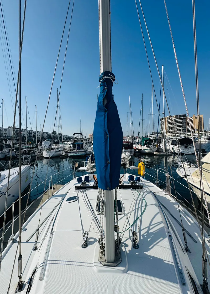 Slide: The Image of 1998 Catalina 320 sailboat docked in a marina, clear blue sky. - 12