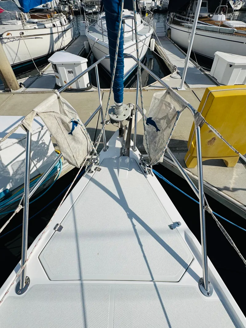 Slide: The Image of Deck view of a 1998 Catalina 320 sailboat docked at a marina. - 13